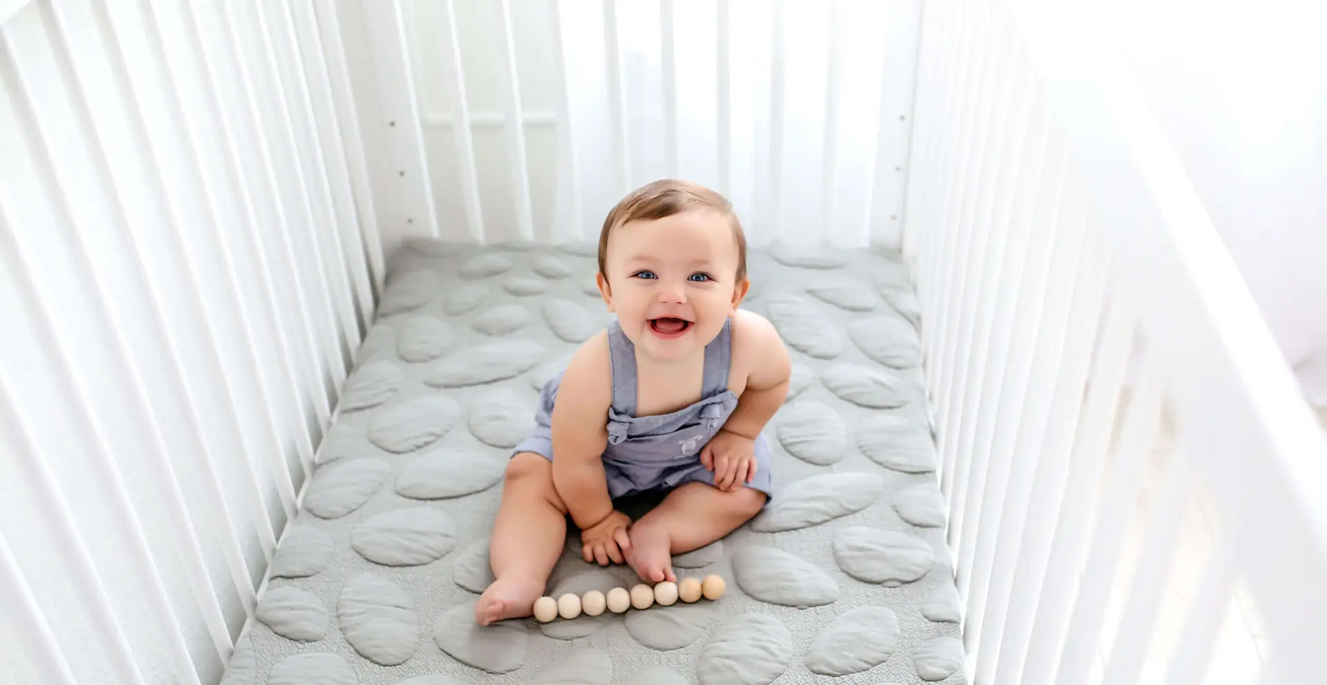Baby In Nursery Crib On Nook Mattress
