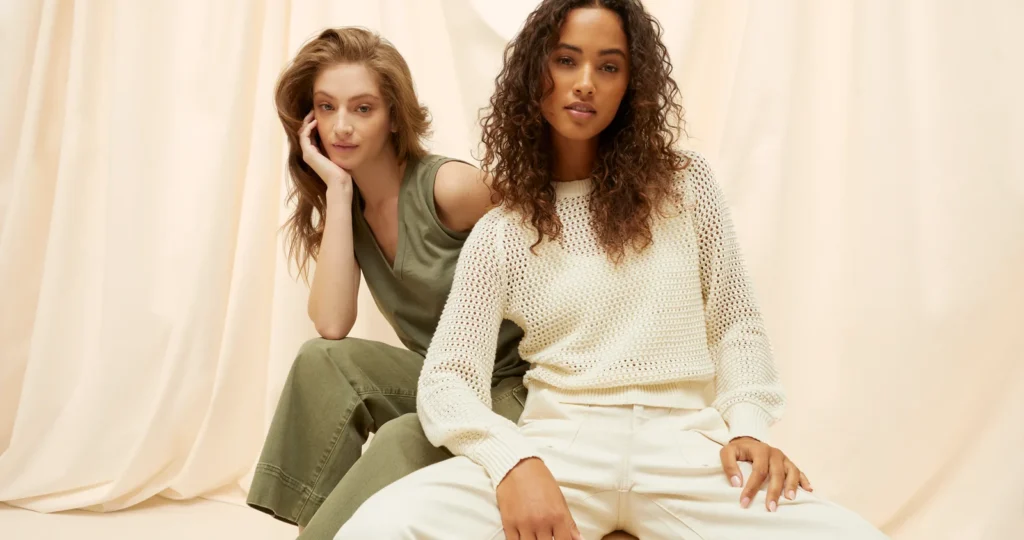EX client highlight: two women in knit apparel posing in a studio
