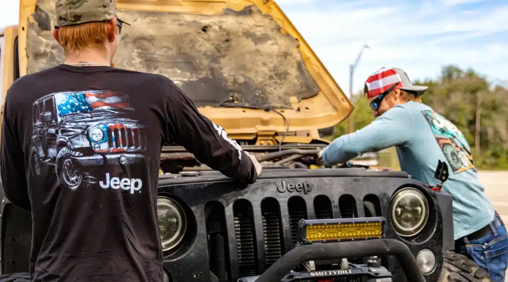 JP client highlight: two men working under the hood of an off-road vehicle