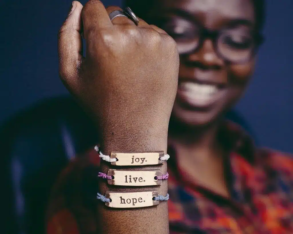 MudLove client highlight: woman wearing joy, live, and hope clay word bracelets