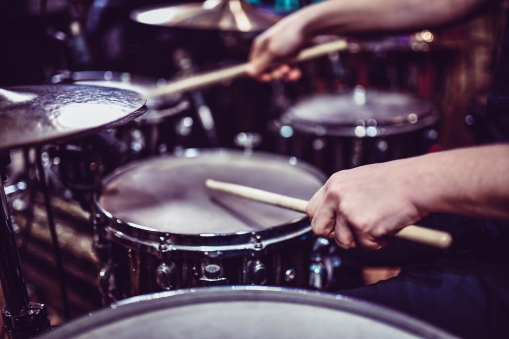 Sam Ash client highlight: drummer playing a drum kit in close-up