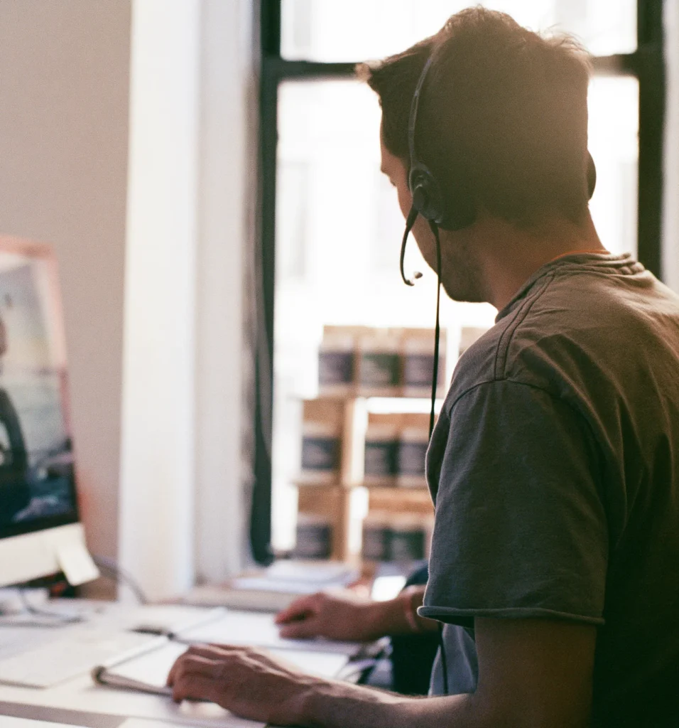 Service agent on a headset listening to a customer call