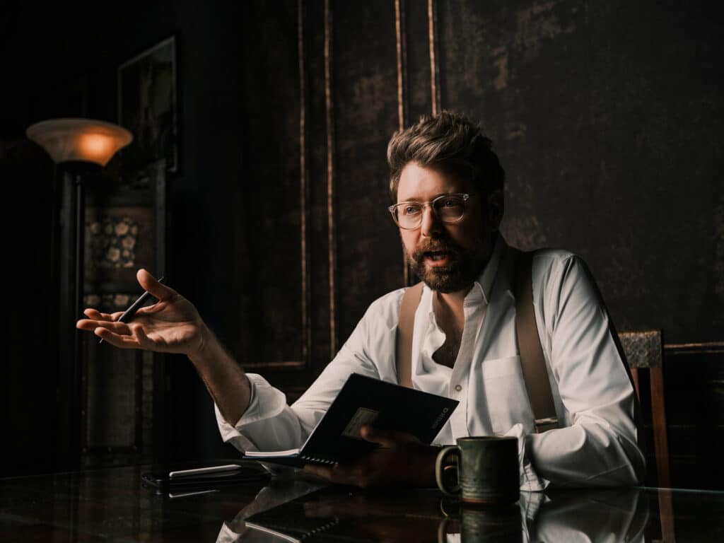 Yates Jarvis at his desk with notebook and pen
